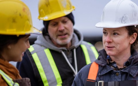 Construction workers discussing safety procedures on site