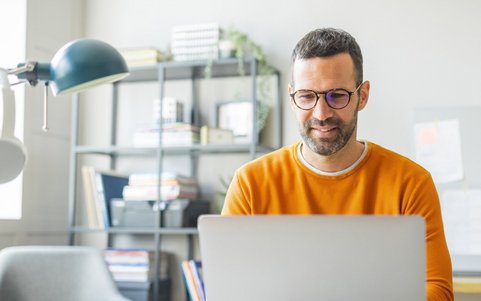 An employee completing online trainings on a laptop.