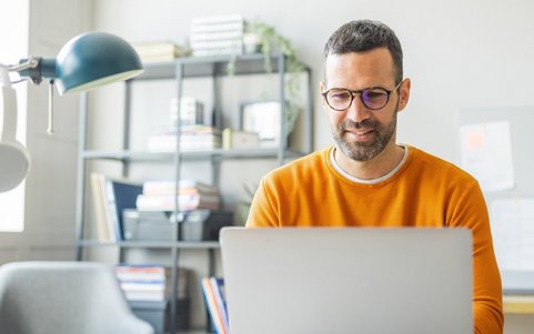 An employee completing online trainings on a laptop.