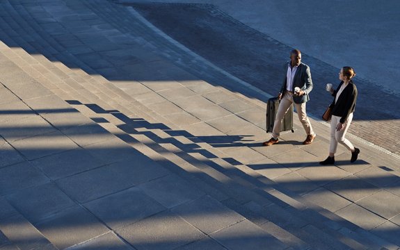 Two business professionals walking outdoors.
