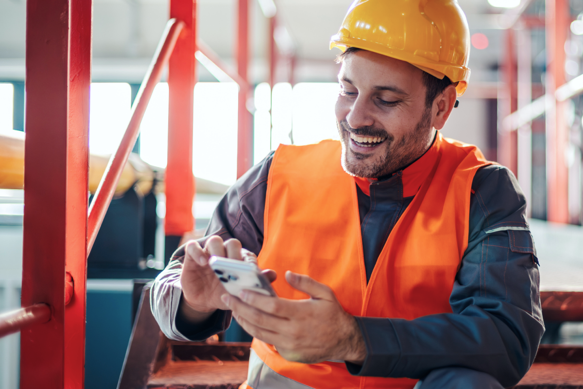 Worker reporting an incident on a smartphone, illustrating mobile digital incident reporting